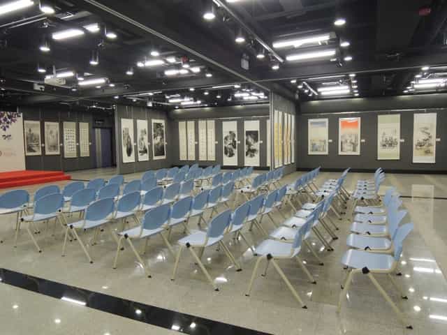 Exhibition Space in Sheung Wan Civic Centre with blue chairs for a seminar event.
