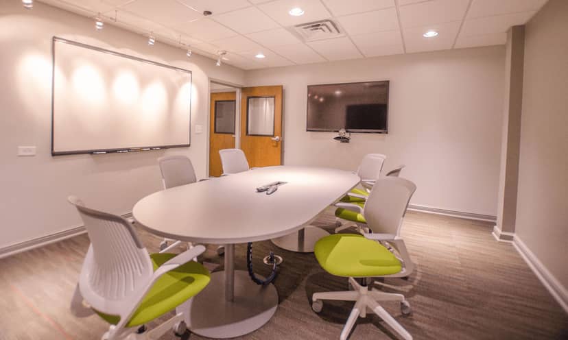 Modern meeting room with oval table, ideal for brainstorming and team meetings.