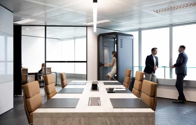 Modern conference room with leather chairs, ideal for professional meetings and events.