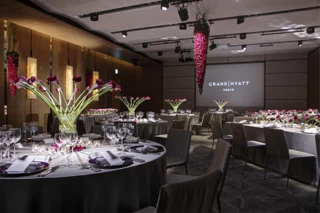 Elegant event space at Grand Hyatt Tokyo with floral centerpieces for corporate gatherings.