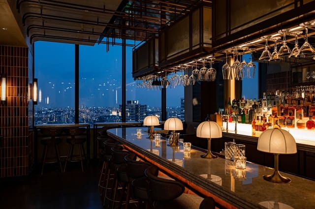 Sophisticated bar at Kimpton Shinjuku Tokyo with city view, perfect for upscale events.