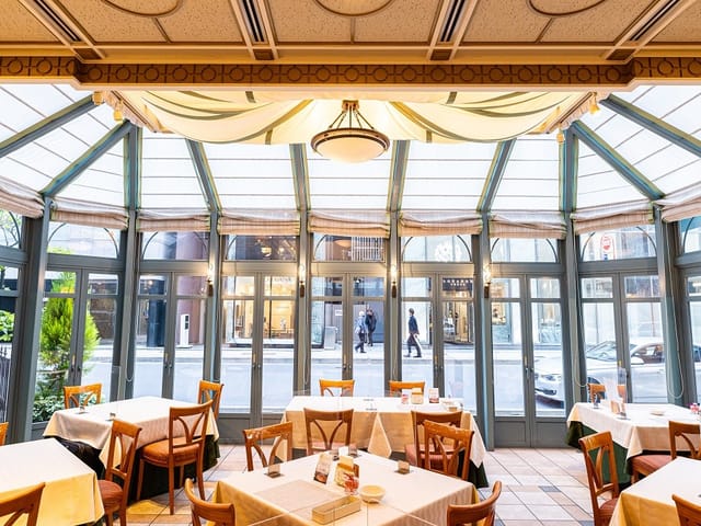 Elegant restaurant dining space with large windows, ideal for meetings and events.