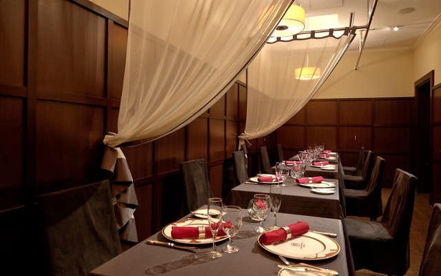 Elegant dining space with red accents for intimate meetings and private events.