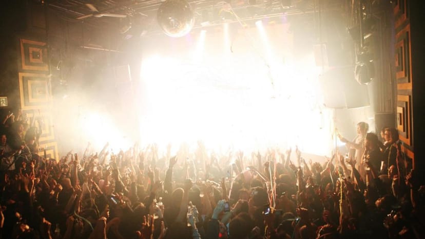 Vibrant nightclub scene at Club Asia with dynamic lighting and energetic crowd celebration.