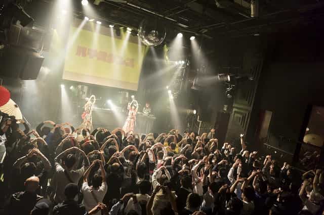 Vibrant nightclub scene at Club Asia with energetic live performance and packed audience.