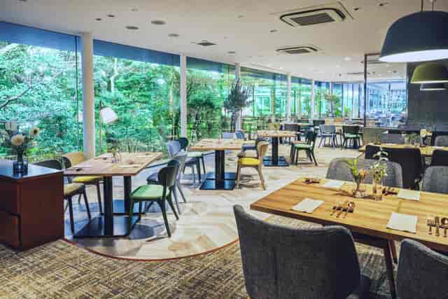 Modern dining space at Hotel Gajoen Tokyo, ideal for events with lush greenery views.