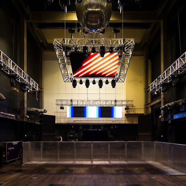 Versatile event space with LED screen for concerts and corporate events.