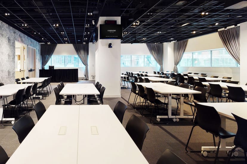 Versatile UDX Conference Room F with natural light, ideal for workshops and corporate events.
