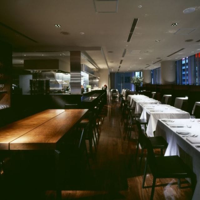 Modern restaurant interior with elegant tables, ideal for corporate events and gatherings.