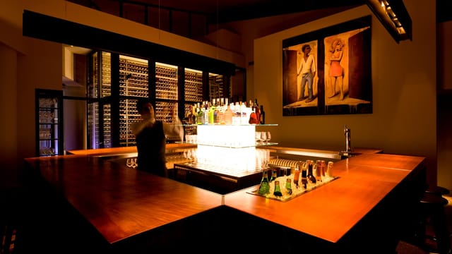 Sleek bar at TWO ROOMS Grill & Bar, ideal for networking events and cocktail receptions.