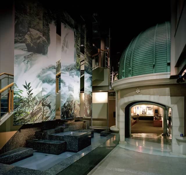 Kōdōkan museum venue with elegant dome and water mural for events and gatherings.