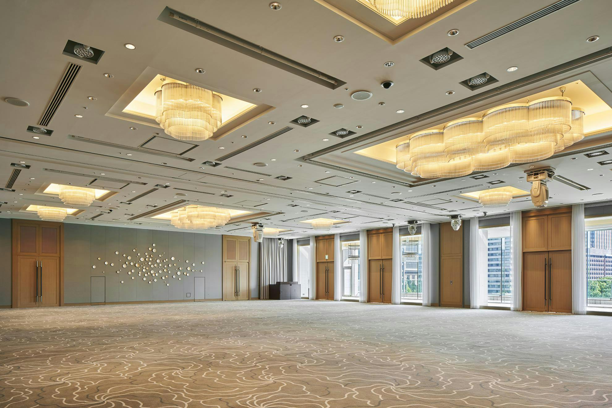 Spacious Meeting Room II at XEX TOKYO with modern chandeliers for corporate events.