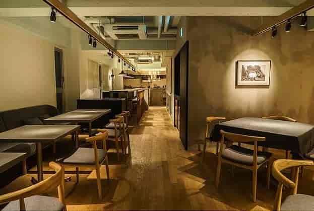 Modern minimalist event space with warm lighting, ideal for intimate gatherings and meetings.