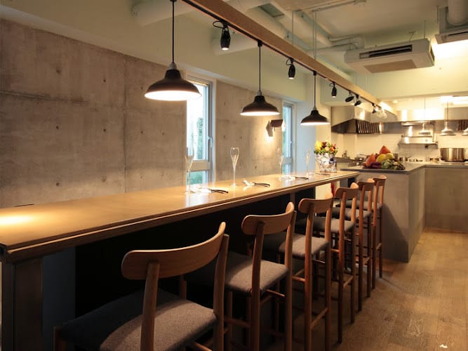 Modern minimalist restaurant event space with sleek bar, ideal for gatherings and networking.