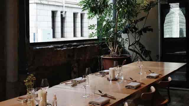 Private meeting room with wooden table, ideal for corporate events and gatherings.