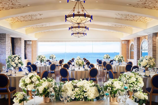 Elegant wedding venue at Sheraton Grande Tokyo Bay with floral centerpieces and stunning views.