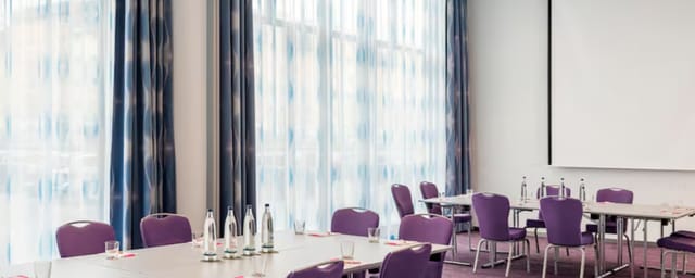 Meeting Room 1 in Nhow Berlin with modern purple chairs, ideal for professional events.