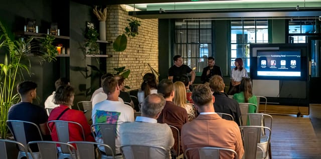 Modern event space in Shoreditch with greenery for panel discussions and networking.