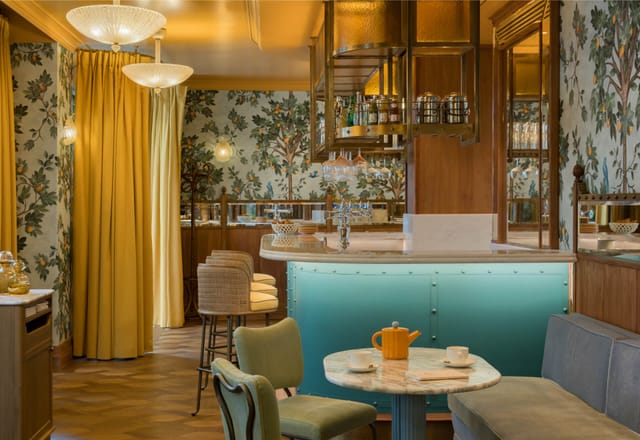 Elegant restaurant event space with floral wallpaper, perfect for gatherings and meetings.