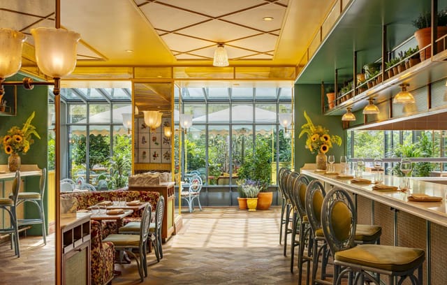 Vibrant event space in La Fantaisie, ideal for networking and gatherings with greenery.