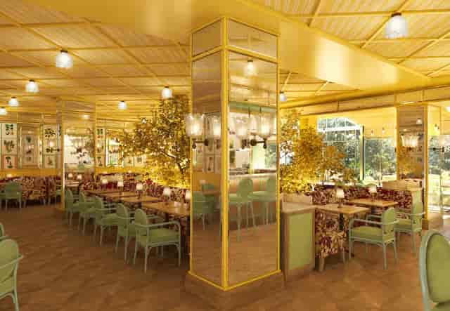 L'Atelier dining space with warm yellow tones, perfect for events and gatherings.