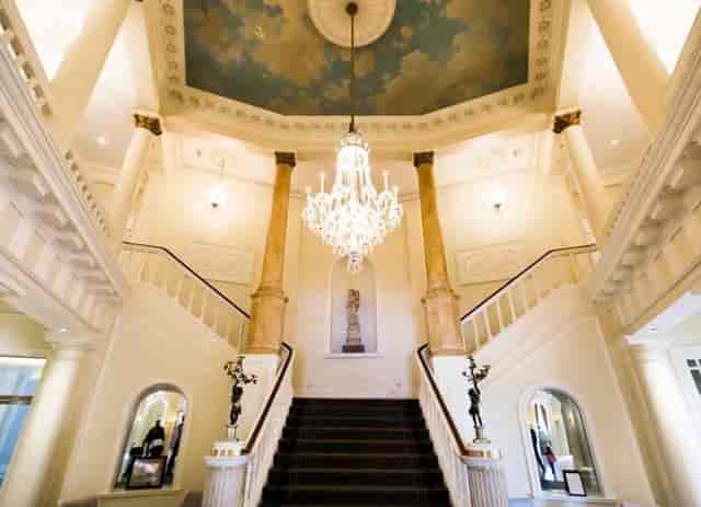 St Davids Suite foyer with grand staircase, chandelier for upscale events in Cardiff.
