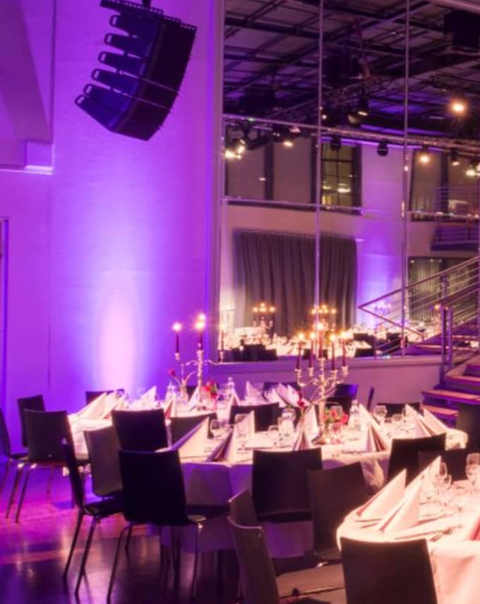Elegant dining area with candelabras for upscale events at Palais Kulturbrauerei.