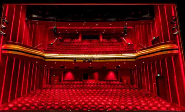 Vibrant red-accented theater with tiered seating for dynamic events and performances.