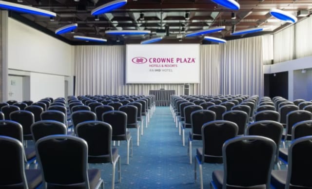 Conference room at Crowne Plaza Zurich with black chairs, ideal for corporate events.