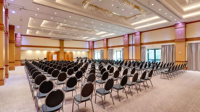 Conference area with black chairs and natural light, perfect for seminars and networking.