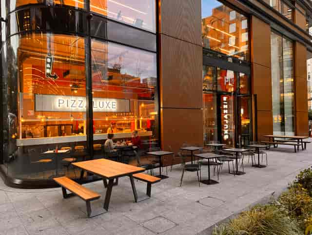 Modern dining venue with outdoor seating for casual meetings and networking events.