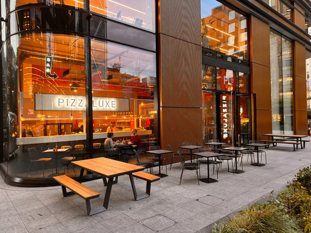 Modern dining venue with outdoor seating for casual meetings at PizzaLuxe Principal Place.