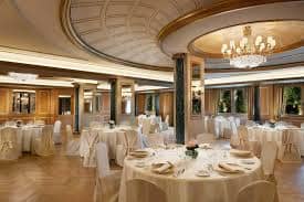 Elegant banquet hall with ornate ceiling, perfect for weddings and corporate events.