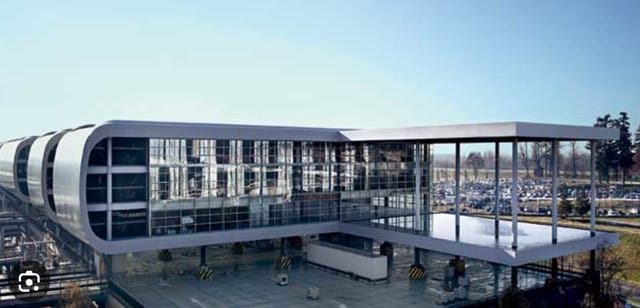 Modern event venue Pegasus B at Sheraton Milan Malpensa with glass facades for conferences.