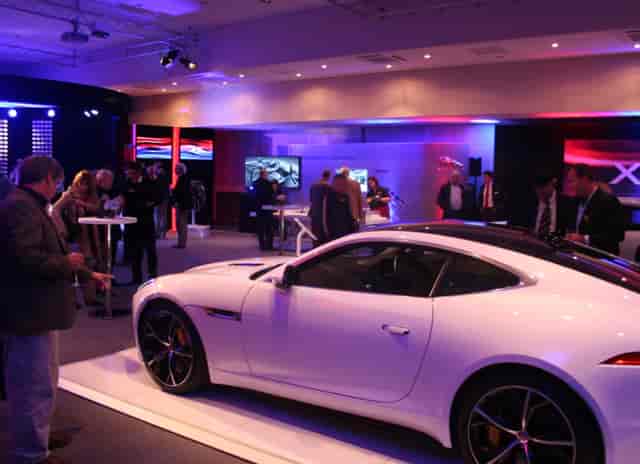 Luxury car centerpiece in upscale Haynes Motor Museum meeting room for automotive events.