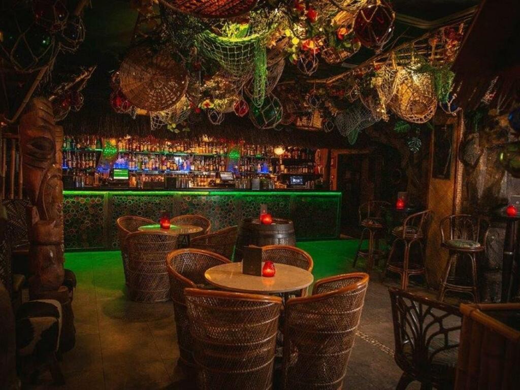 Kai Wai Cove at Sugar Cane Tiki Bar, vibrant tiki decor for unique events and parties. - Banner