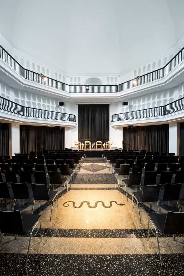 Kuppelhalle event space with tiered seating, ideal for presentations and discussions.
