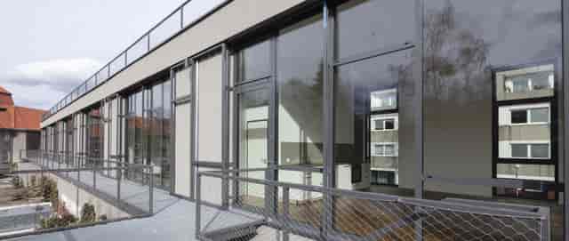 Modern event venue with large windows, ideal for meetings and networking.