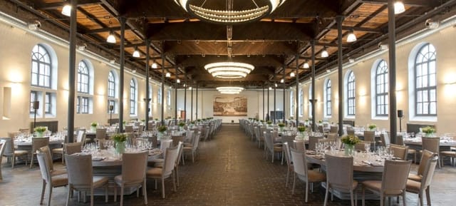 Elegant event venue with round tables, ideal for weddings and corporate gatherings.
