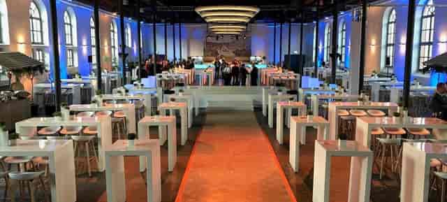 Spacious Bolle Meierei venue with high-top tables for networking and cocktail events.
