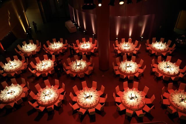 Elegant banquet setup with round tables in ARTrium for formal events and gala dinners.