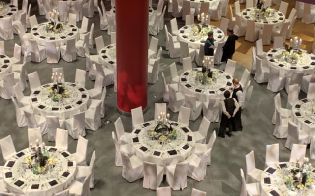 Elegant banquet hall with round tables, perfect for formal events and galas.