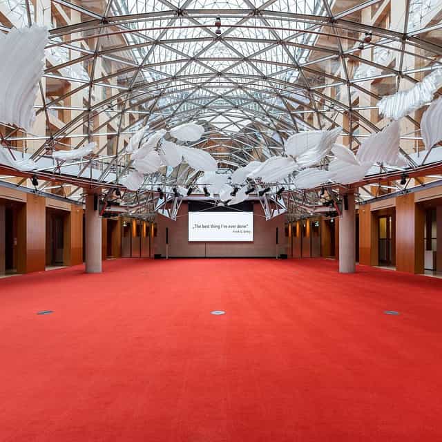 Spacious AXICA event venue with high ceiling, ideal for conferences and workshops.