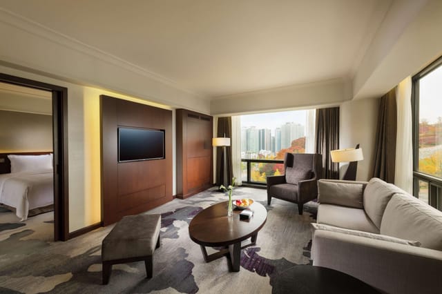 Luxurious hotel suite in Millennium Hilton Seoul with city view, ideal for meetings and events.