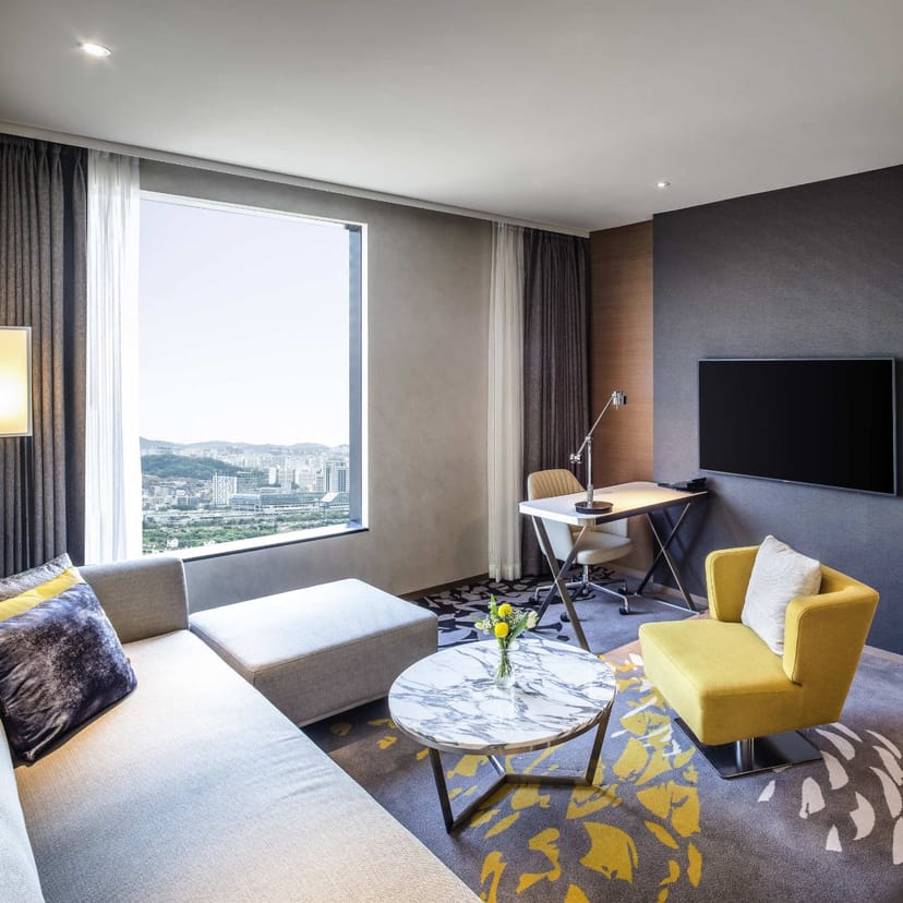 Modern hotel suite in Novotel Seoul with city views, perfect for business events.