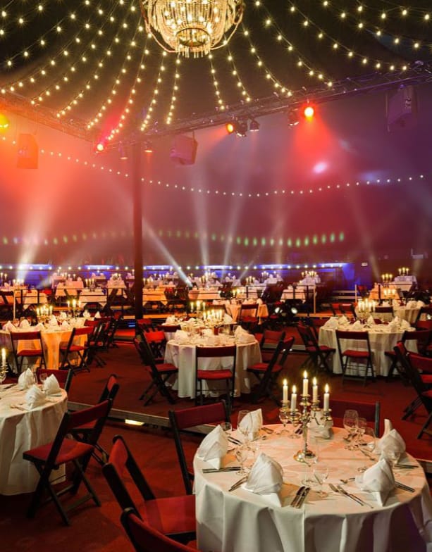 Elegant gala event space with candlelit tables in TIPI AM KANZLERAMT.