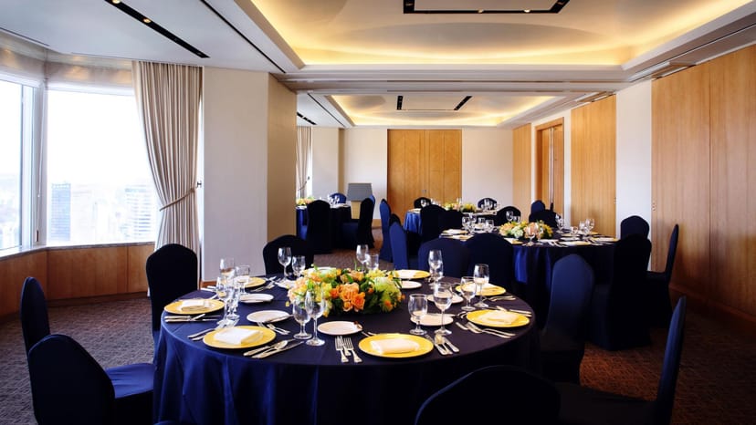 Elegant meeting room at Seoul Garden Hotel, set for formal dinner with navy linens.