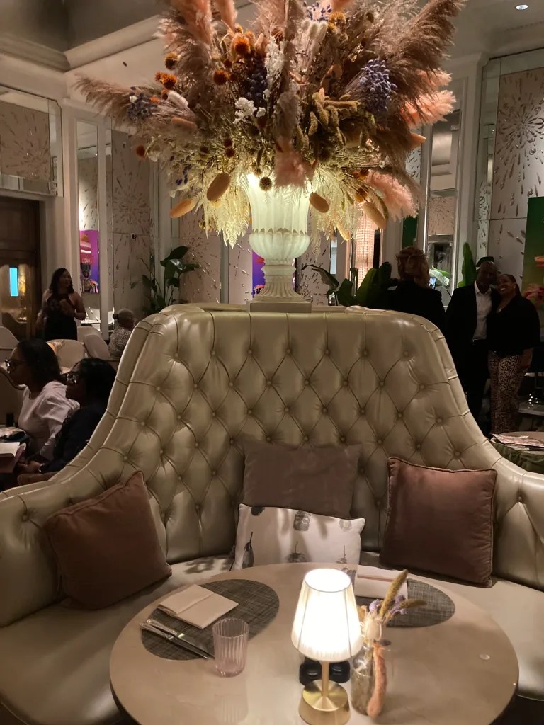 Elegant floral arrangement centerpiece in Palm Court, The Langham, London for upscale events. - Banner