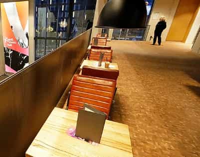 Sleek event space with wooden tables at Uber Eats Music Hall for networking and meetings.