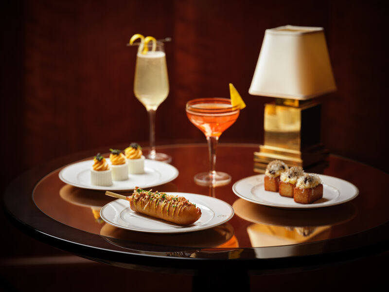 Gourmet appetizers and cocktails at Le Magritte Bar for upscale events and networking. - Banner